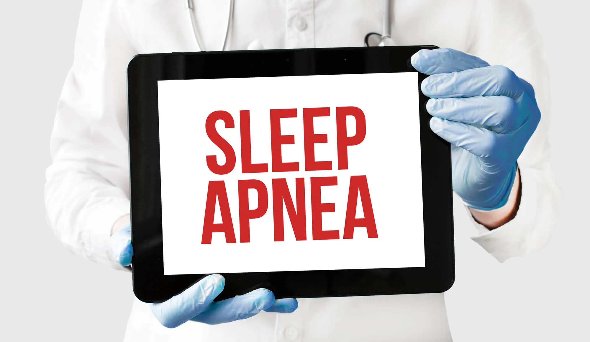 sleep apnea dentist las vegas holding a tablet with words sleep apnea
