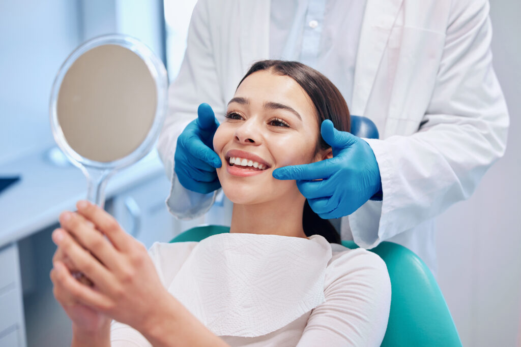 Dentist, mirror and woman check smile after teeth cleaning, braces and dental consultation. Healthcare, dentistry and happy female patient with orthodontist for oral hygiene, wellness and cleaning.