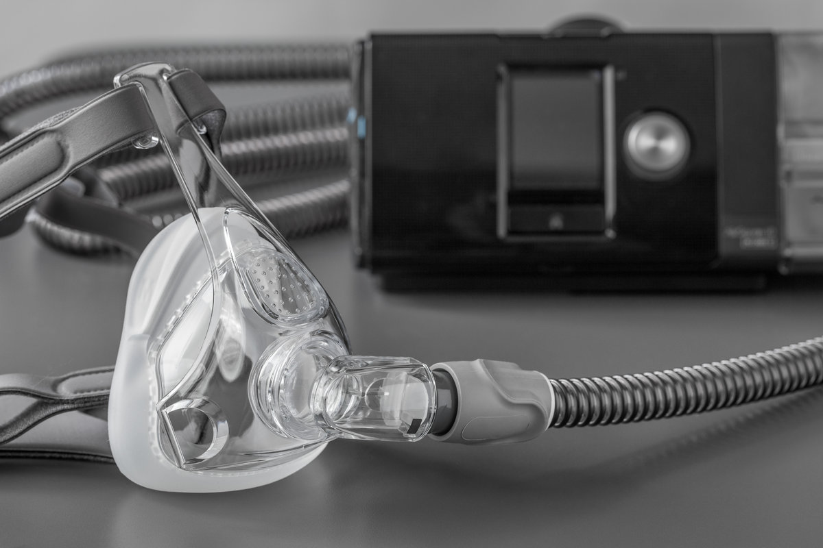 Sleep apnea CPAP mask on the grey table