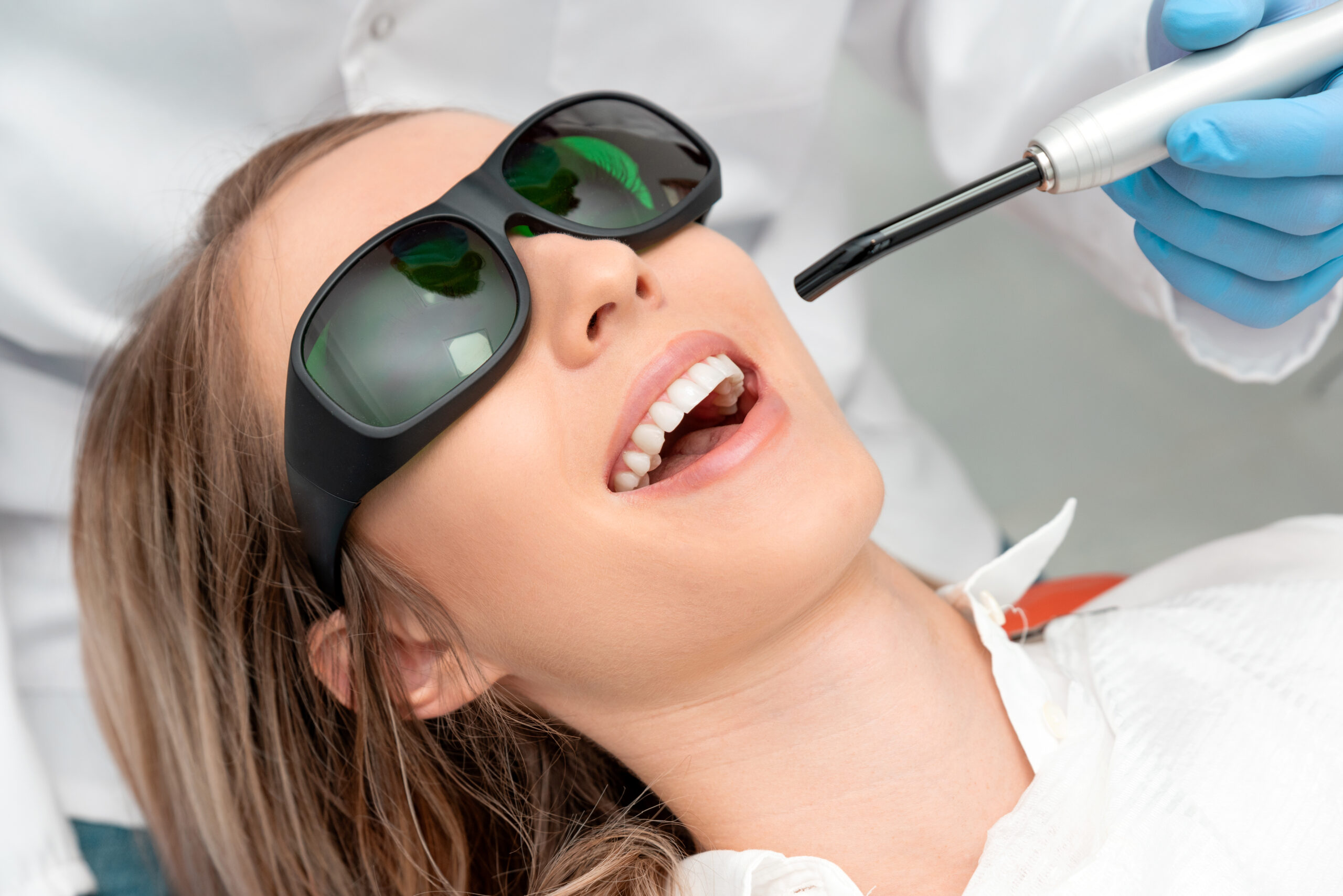 Using a modern method of laser teeth treatment. Dental care, perfect smile