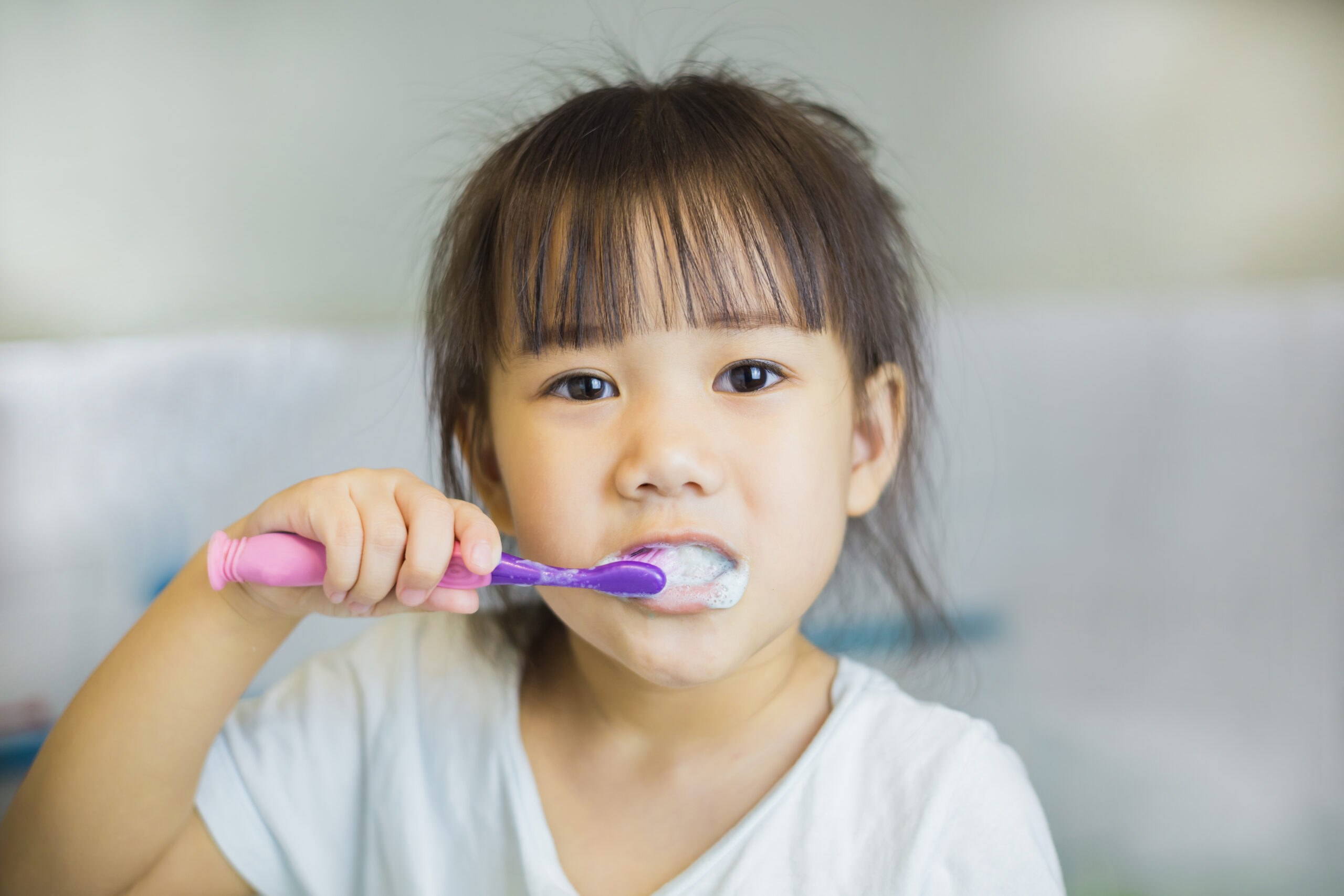 Child brushing teeth, illustrating the ADHD and oral health connection for parents
